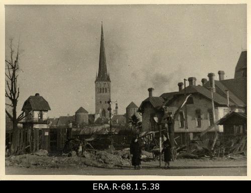 Consequences of the March bombing in Tallinn: bomb crater over the crossing of Kopli Street, the Olviste Church and the towers of the city wall