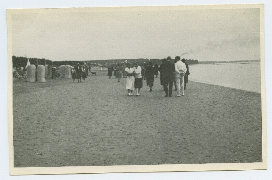 People walking on the beach of Pirita Tallinn, on the left side of the beach building.