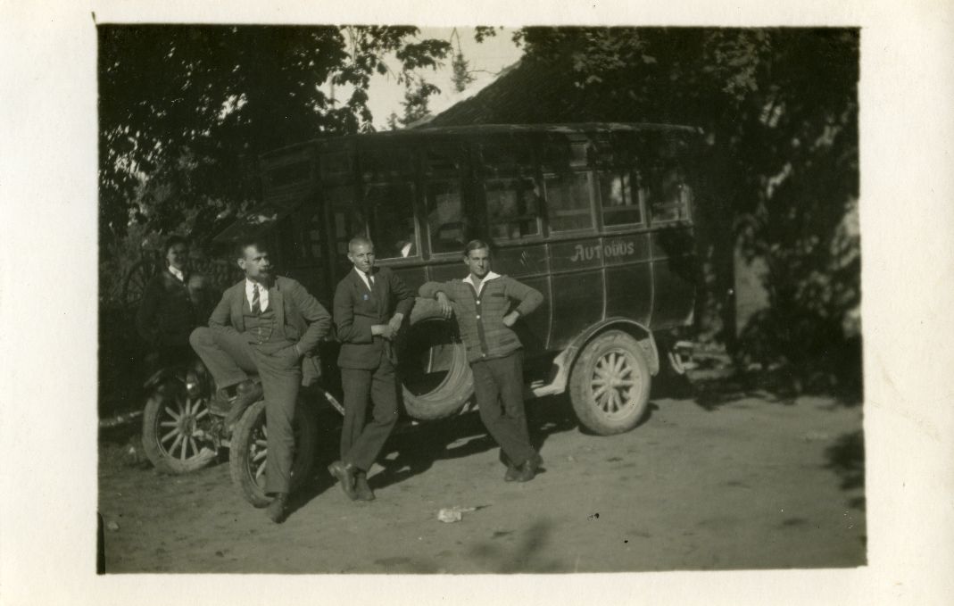 Bus in Saaremaa, three young men in front of the bus
