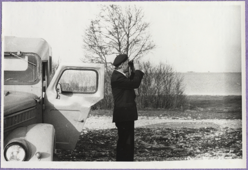 Haapsalu Fishing Inspectorate. On the left open front door landscape car GAZ-69, on the right man with binocular. At the back of the sea.