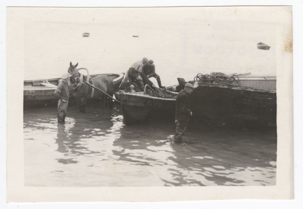 Wooden fishermen charging nets to motor boats