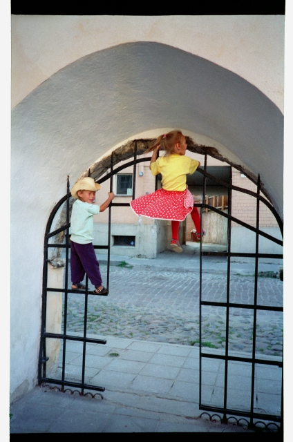 Children climbed at the gate on the Russian street in the Old Town of Tallinn