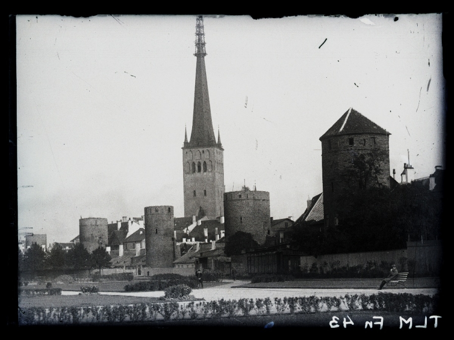 Tallinn, the old city wall with towers and the church of Olevis, view from the west.