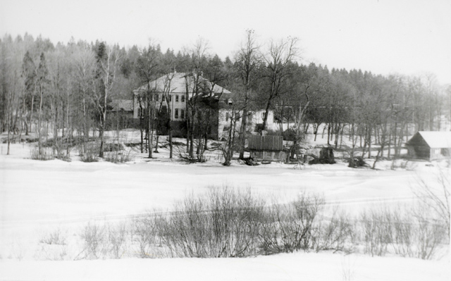 Buildings of the Rogos manor, winter view over the lake