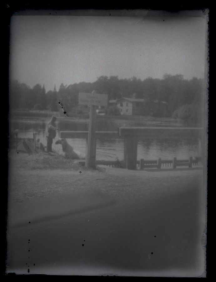 A man on the river, on the other side to see the house.