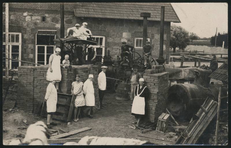 Postcard, People at the courtyard of Võhma Joint Milk Service, a number of equipment, stones