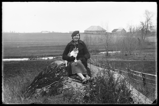 Women's Clothes - woman sitting on stone with cat