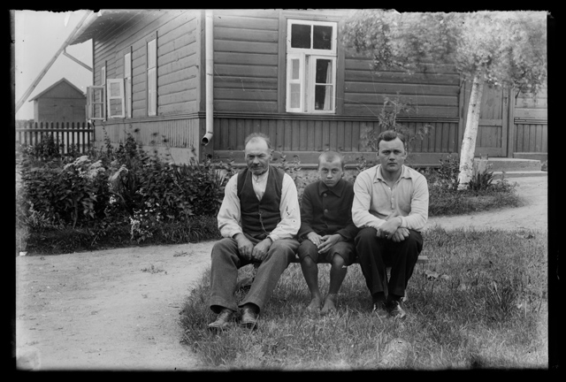 Two men and boy in the garden on the bench