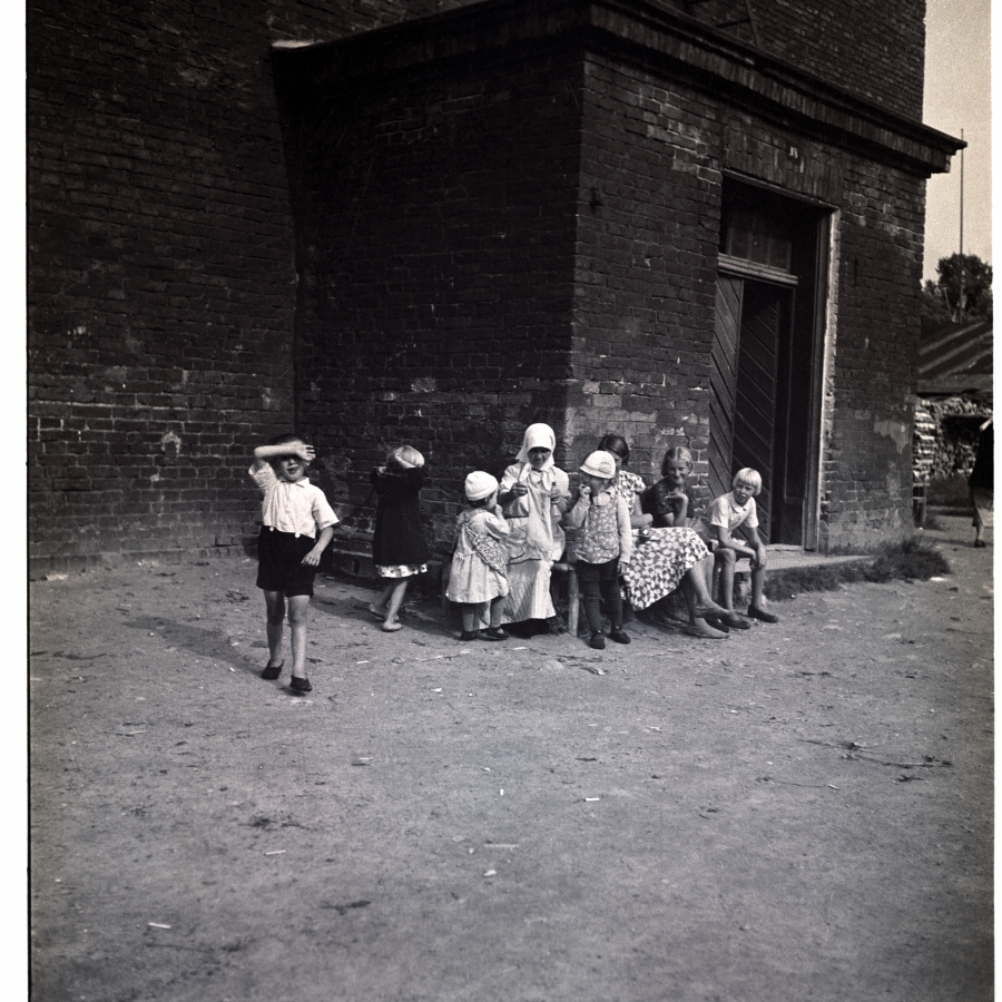 Pärnu, women and children in the background of the brick building.