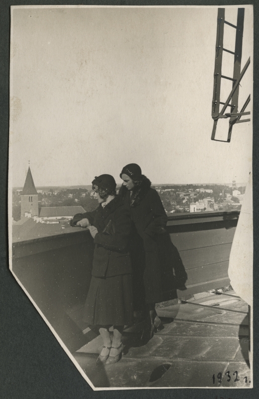 Two women in coats and hats in the Tartu Star Tower, in the courtyard at the balcony.