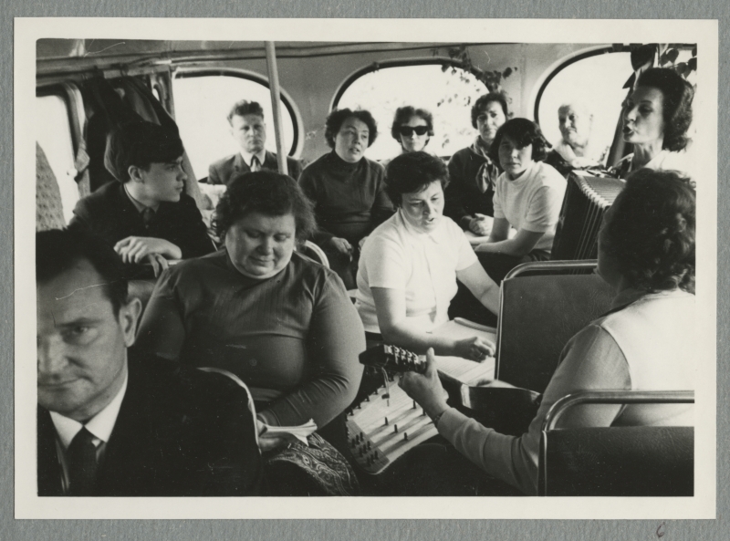 Riga tour company singing in the bus, with an accordion and guitar.