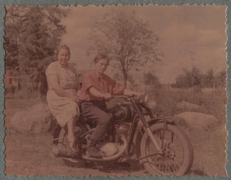 Boy and woman on a motorcycle.