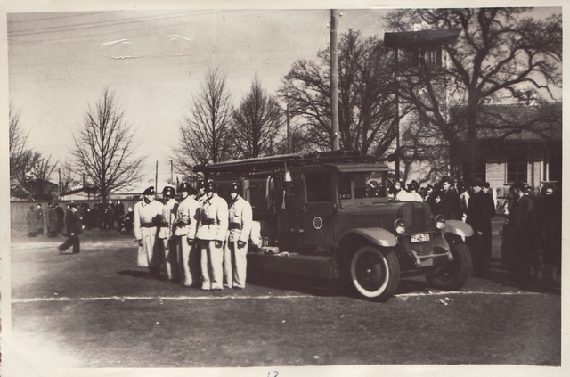 Firefighting team in front of the fire car in 1949.