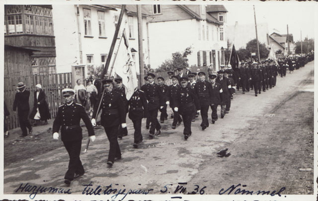 Firefighters marching with flags.