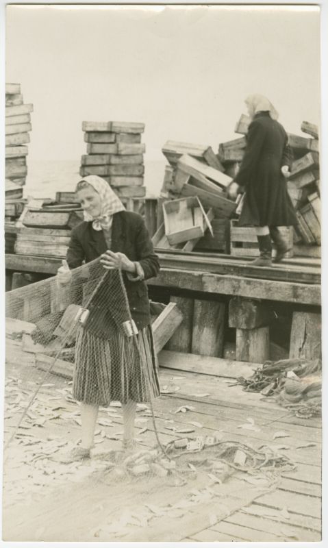 Woman with fishing net at Kihnu Harbour
