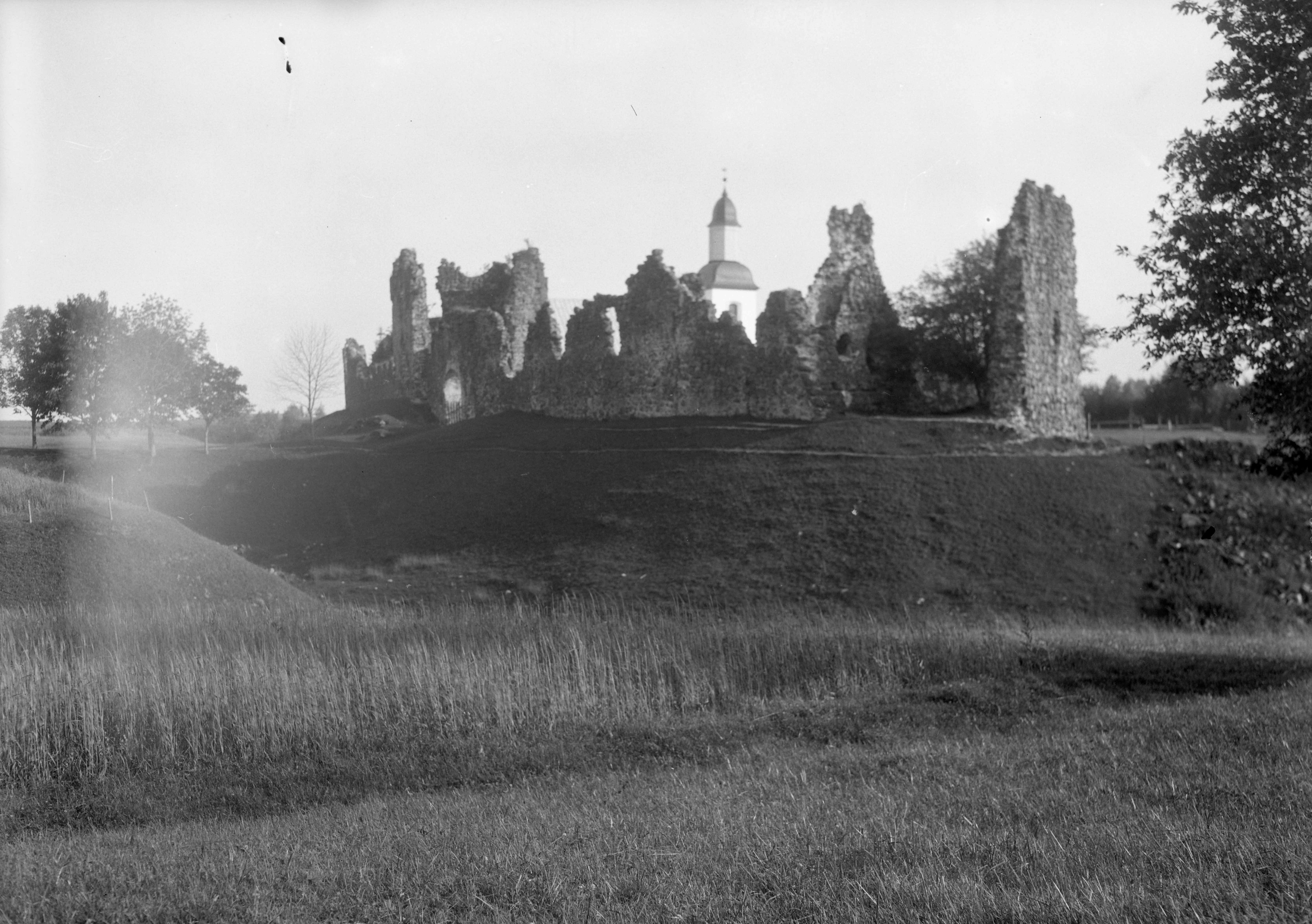The ruins of the castle. View from S. Background Karksi Church Tower