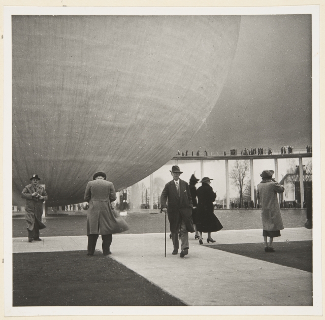 Audience in the New York World Exhibition; background exhibition theme building The Perisphere and Trylon