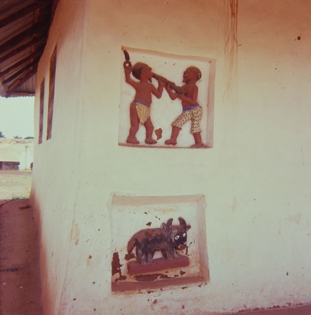 Painted human and animal relief pictures on the wall of the house
