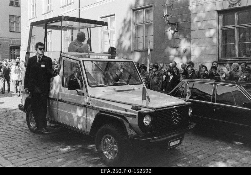 His Holy Pope John Paul II, on his legendary bullet-resistant glass building, traveling through the city by Mercedes.