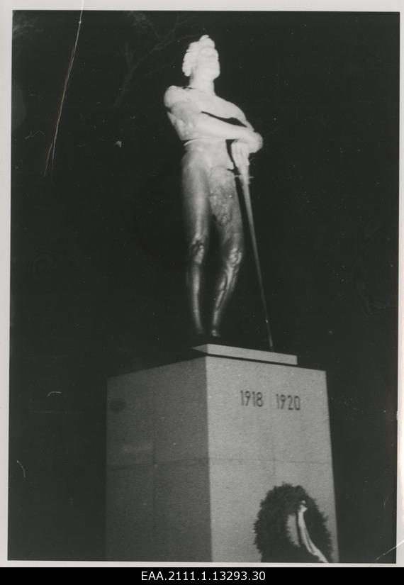 The eve of the 20th anniversary of the Republic of Estonia in Tartu, the choir on the foot of the monument pillar of the War of Independence "Kalevipoeg" illuminated with the projector