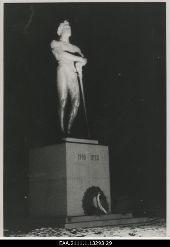 The eve of the 20th anniversary of the Republic of Estonia in Tartu, the choir on the foot of the monument pillar of the War of Independence "Kalevipoeg" illuminated with the projector