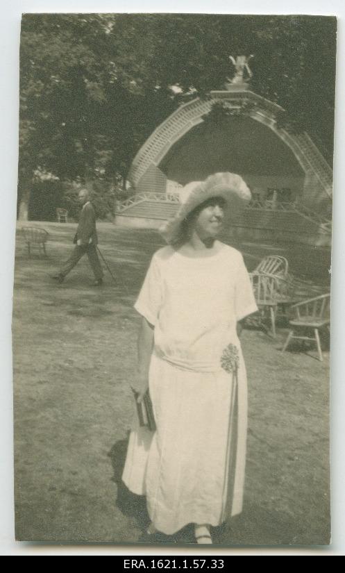 An unknown woman in the park in the background of a small outside