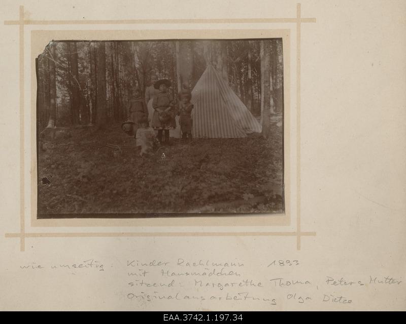 Family of Raehlmanns children with a roommate in park forest in front of a barbecue tents
