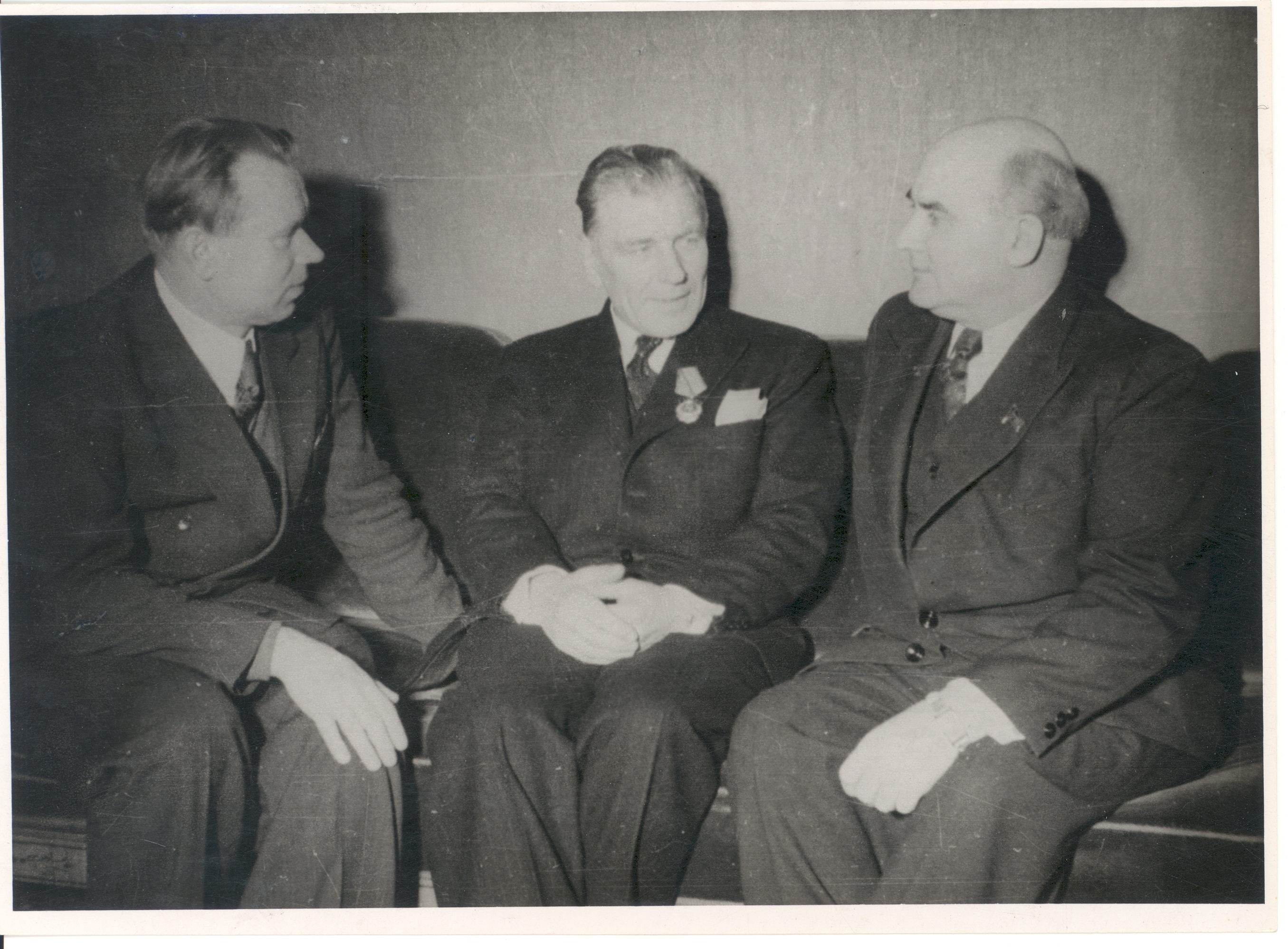 J. Vares-Barbarus (best the first) converses with a. Lauter (in the middle) after receiving the Order of Lenin