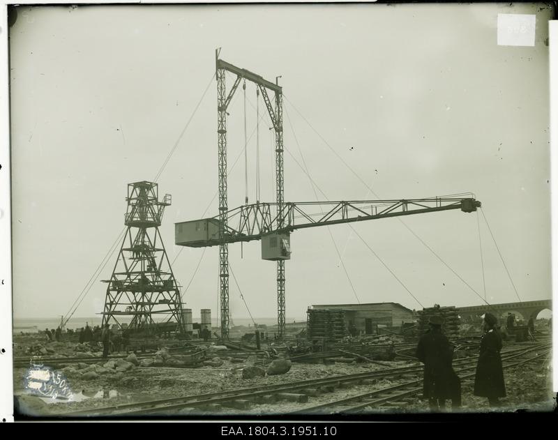Port crane, two men on the right