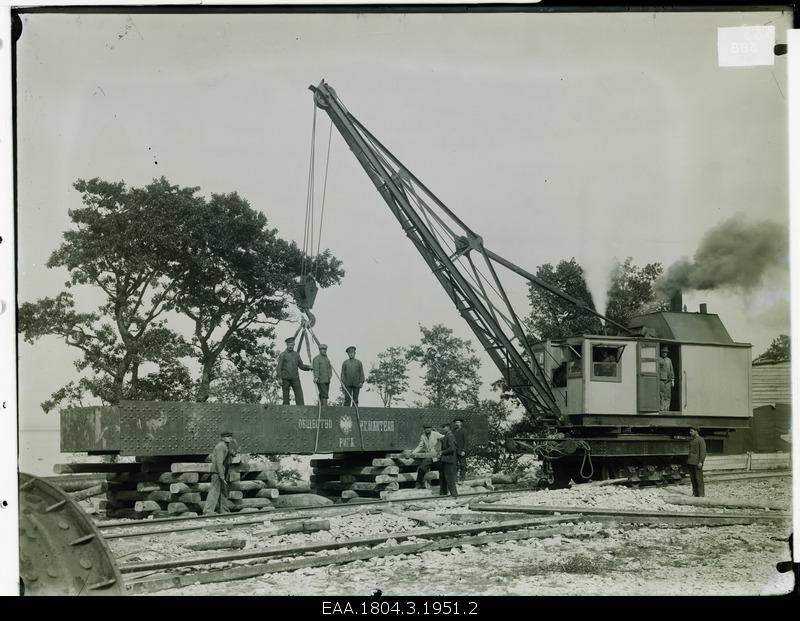 Construction work, front of the crane and company of men