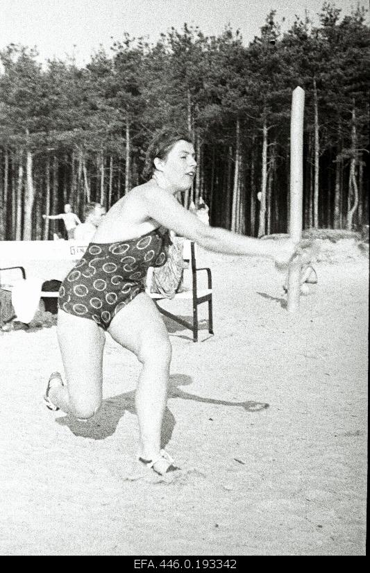 Woman at the beach of Pirita playing volleyball.