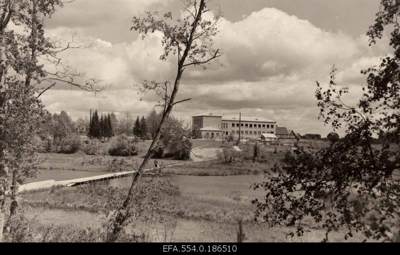 View from the cemetery to the construction of the primary school building of Suure-Jaani, the bridge built by students across the lake and the stream flowing to the Great-Jaani lake (in the outset).