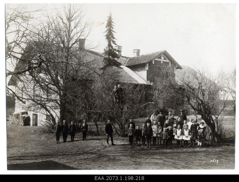 Unidentified Latvian schoolhouse, school family at the forefront