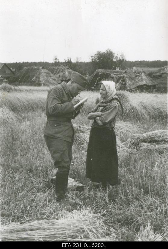 German occupation in Estonia. Professor Mägiste is talking to Uudova Vadja's wife on the rye field.