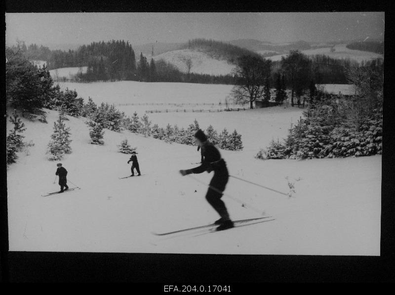 Winter landscape from Otepää. On the front of 3 skiers.
