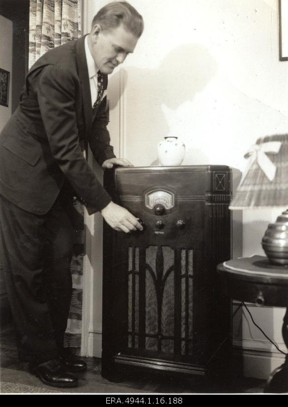 Ernst Jaakson listening to news at his home.