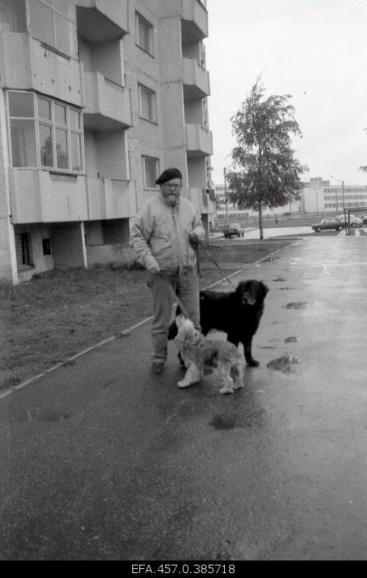 Film director and operator Rein Maran with dogs in front of his home.