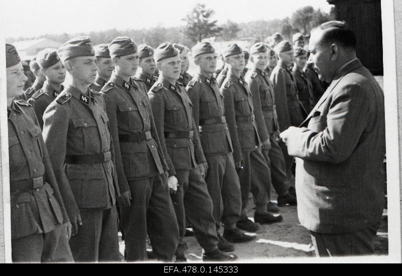Hjalmar Mäe, Head of the Estonian Self-Government, welcomes 20. Young soldiers of the Estonian SS Division.