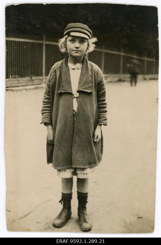 A portrait of a bright-headed girl with a school coat. Removes iron.
