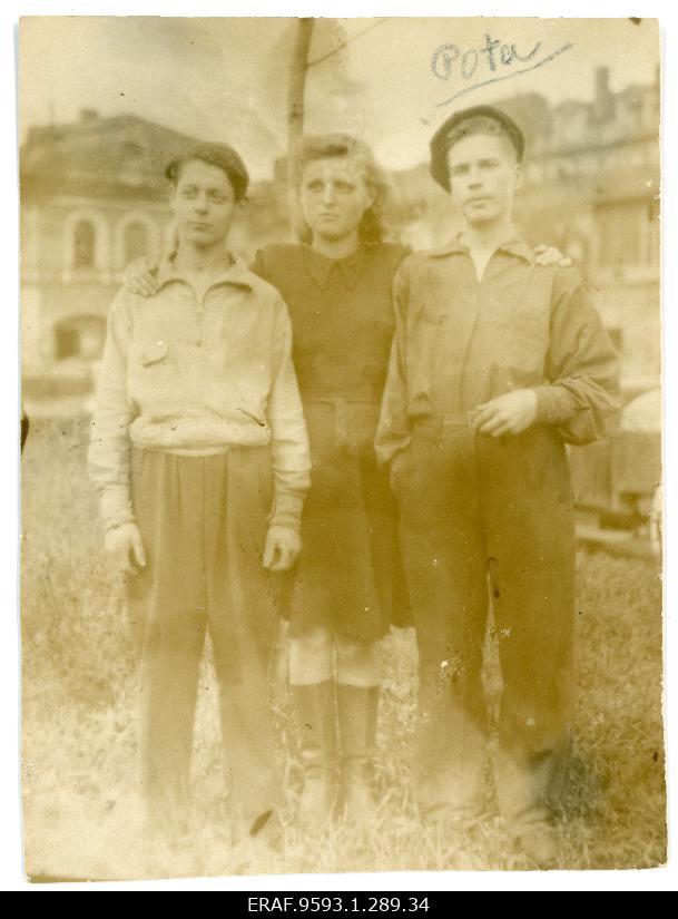 Photo in the background of two young men and one girl's houses.