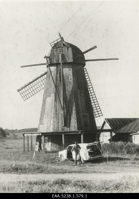 View of the Angla windmill and the man and car in front of it