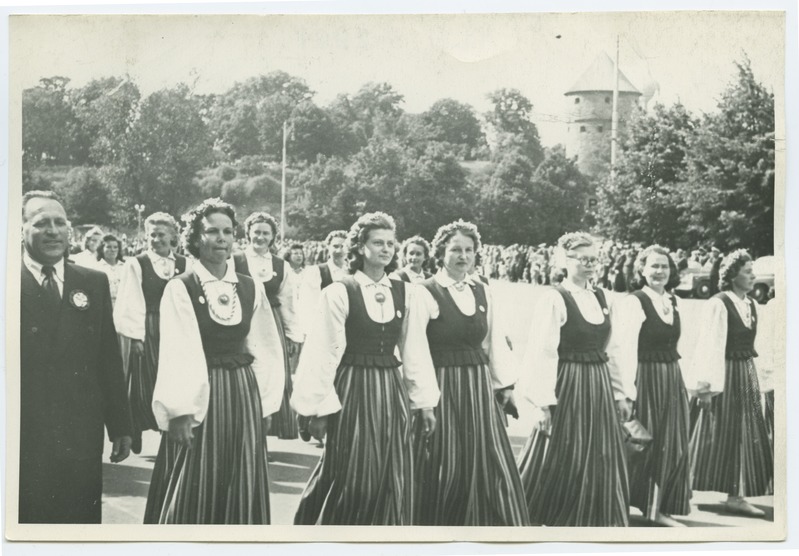 The 1950s song festival in Tallinn, women singers in folk clothes on a train walk in the Winning Square.