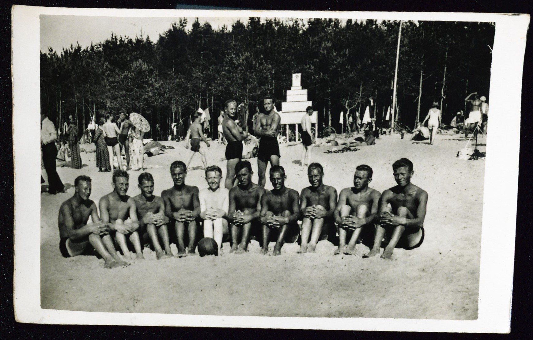 A number of sunny young men on the beach
