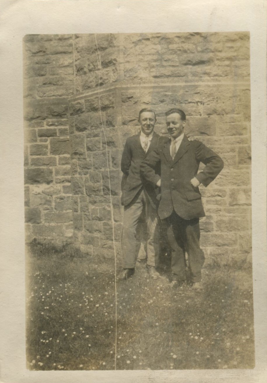 Two men standing in front of castle walls