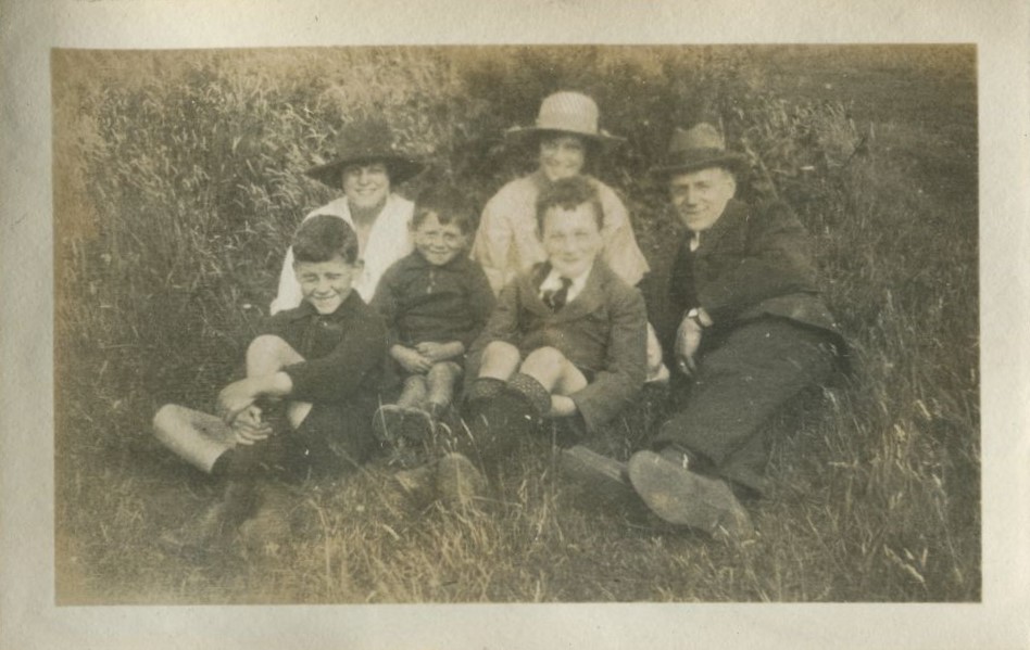 Family group seated on the grass