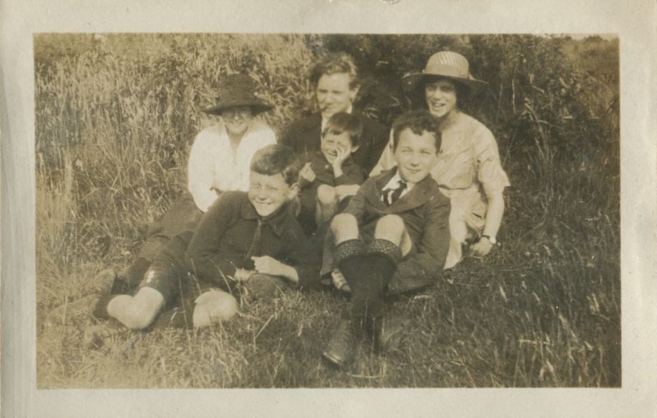 Family group seated on the grass