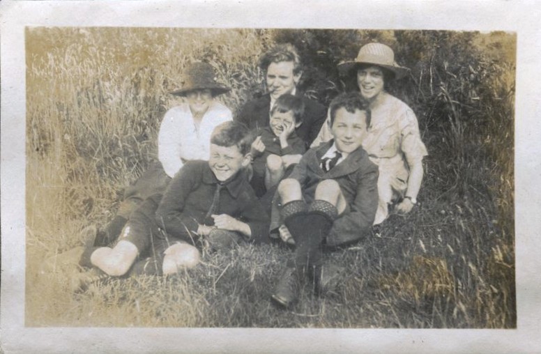 Family group seated on grass, Patcham 1920