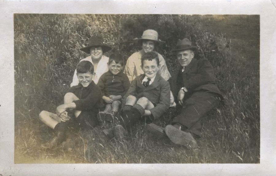 Family group seated on grass, Patcham 1920