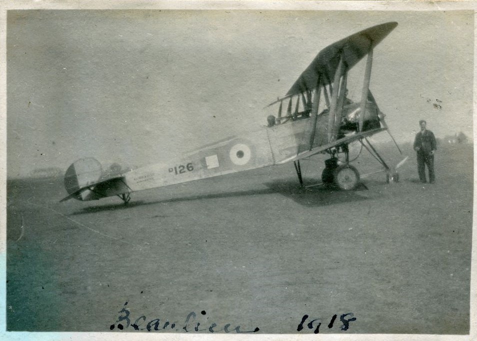 Avro 504 bi-plane with man standing by the propeller, Beaulieu, 1918