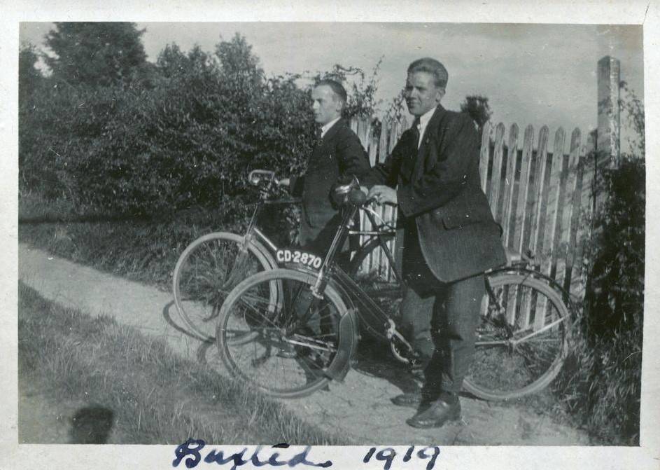 Two men with bicycles in front of a gate, Buxted, 1919
